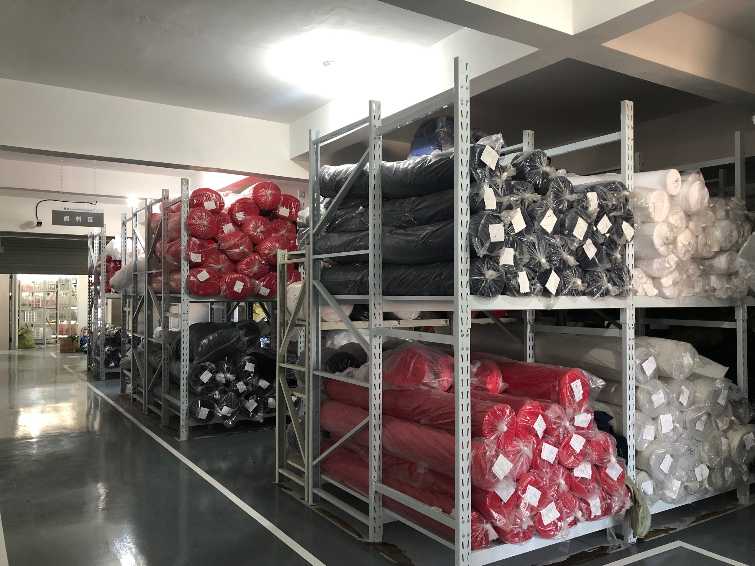 Garmentown quality inspector performing 100% final inspection on finished garments at manufacturing facility in China