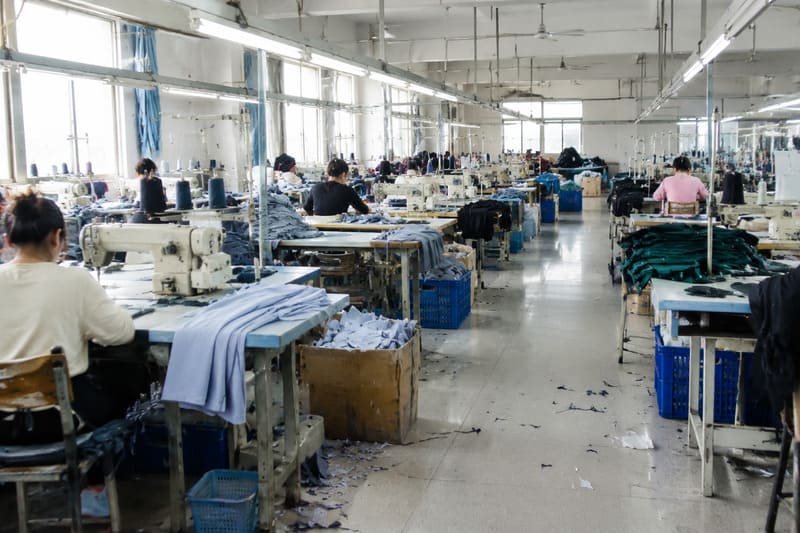 Inside a clothing factory production line showing sewing stations